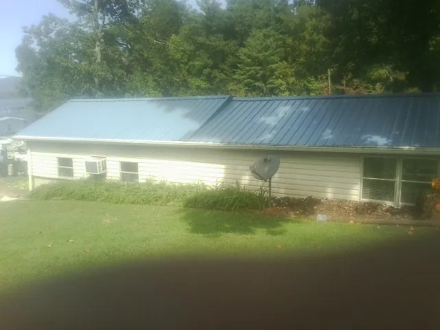Blue metal roof running the length of a single story home in Olney Springs